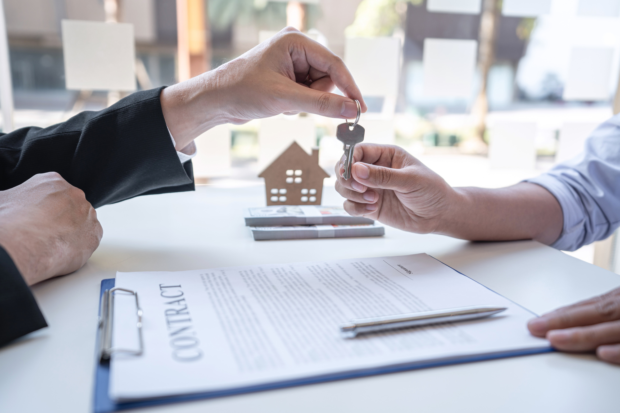 Real estate agent are presenting home loan and sending keys to customer after signing contract to buy house with approved property application form, Insurance Home concept